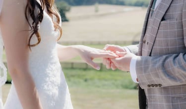 Groom placing a ring onto the finger of the bride