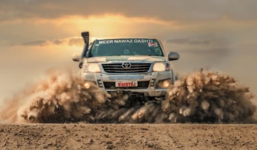 a truck driving through a dirt road