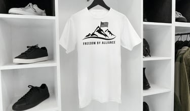 a white t - shirt with a mountain view of a mountain range