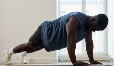 A man doing pushups on a yoga mat during a home workout routine for strength training.