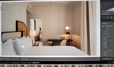 A suite at Regent Carlton Cannes with a bed in the foreground and Rémi Lefèvre in the background