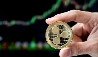ripple xrp token in someones hands with charts in background