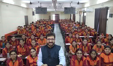 Mentor with a large group of students in a classroom setting.