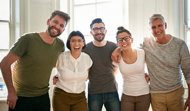 a group of people standing for a team photo showcasing the dynamic of the company