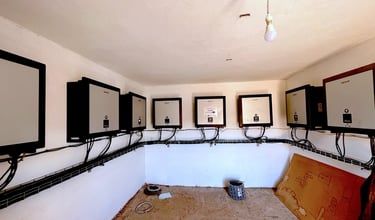 a room with multiple solar inverters on the wall