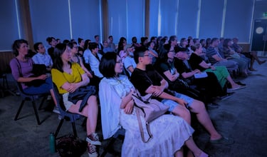 Diverse audience enjoying a cozy film screening at Auckland International Film Club.