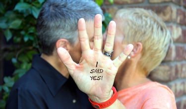 a middle aged couple kissing during their commitment ceremony