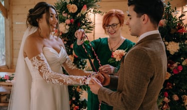 Celebrant leading a handfasting ceremony with a wedding couple