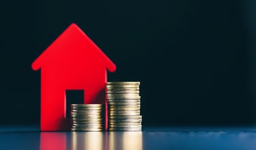 house with coins on side for real estate investing