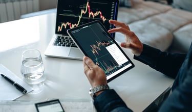 person with interactive investing chart and a calculator