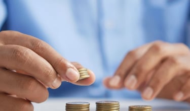 gold coins on table representing beginners guide to gold ira