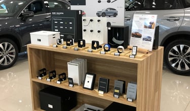 Workshop with technicians repairing a car body in a clean, organized automotive service center