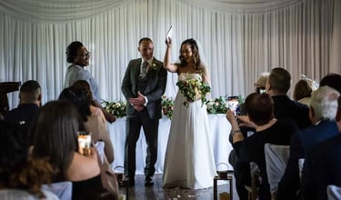 newly-weds holding their wedding certificate in the air
