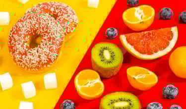 a doughnut and sugar cubes next to fruit