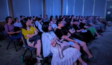 Diverse audience enjoying a cozy film screening at Auckland International Film Club.