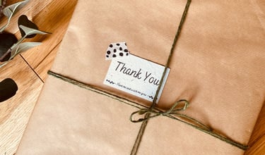 A painting packaged nicely in brown paper and green string