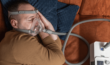 man wearing CPAP machine while sleeping