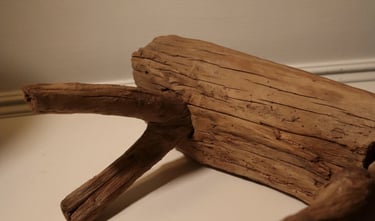 A weathered piece of natural driftwood featuring a textured log and branches for home decor or aquarium use.