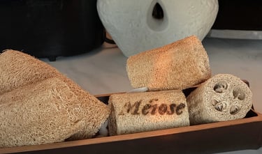 Handcrafted decorative wooden vessels in various wood grains arranged in a diagonal line with dramatic sunlight shadows.