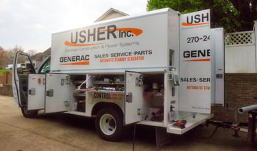 A Usher Inc service truck sitting in front of a house