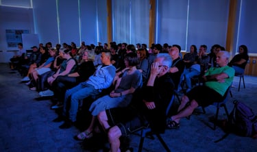 Audience immersed in a movie screening hosted by the Auckland International Film Club.
