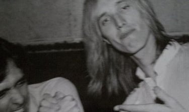 Charlie Kendall arm wrestling with Tom Petty.