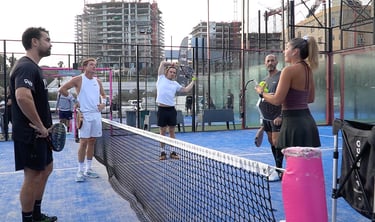 a group of people playing tennis on a court