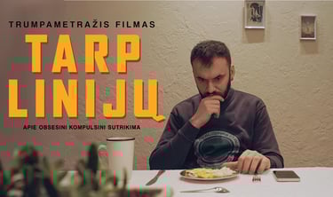 a man sitting at a table with a plate of food