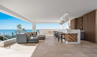 Covered terrace lounge with bar and sea views