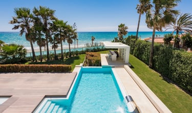 Beachfront pool and garden with outdoor bar pavilion