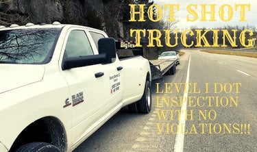 Hotshot truck driver preparing federal compliance paperwork with gooseneck trailer