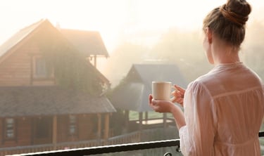 Woman practicing a self-care routine with a peaceful morning tea and mindful moment at home.