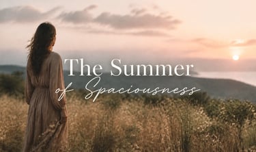 A woman in a linen dress looks at a golden sunset over hills, with The Summer of Spaciousness text.