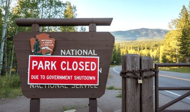"Closed" sign prominently displayed at the entrance to a National Park. AI Generated