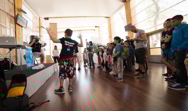 Pencil vs Camera : a group of people standing in a room with Ben Heine and Arthur