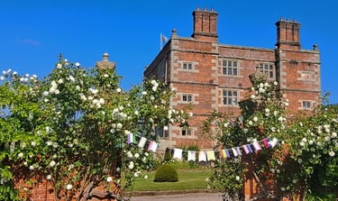 Soulton Hall, Shropshire. LGBTQ Pride bunting hangs in the foreground.