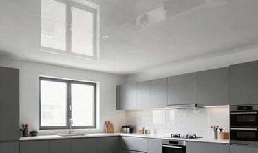 A complex multi-level ceiling with rectangular recessed panels glowing with warm yellow light.