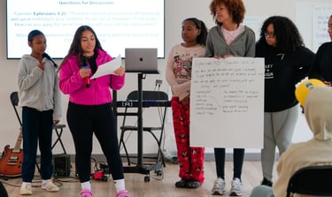a group of people standing around a presentation