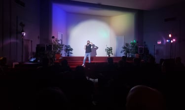 a man standing on stage with a microphone and a microphone