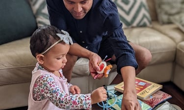 Little girl and father playing with toys