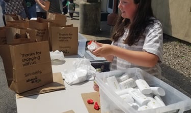 a woman is sitting at a table with boxes of food