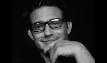 a man with glasses and a beard and glasses