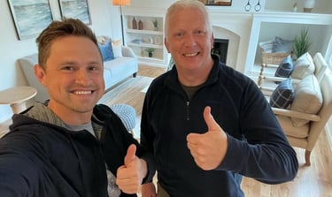 Happy customer posing with Alex, Vision Flooring. On the background there is part of the work we did