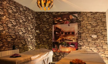 a couple of beds in a room with stone walls
