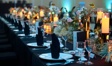 a Annual Dinner with a beautiful table setting with flowers and candles