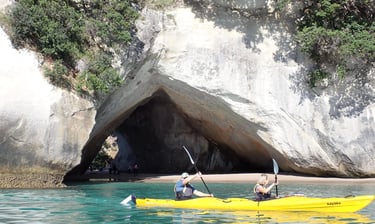 two travellers kayaking in cathedral cove