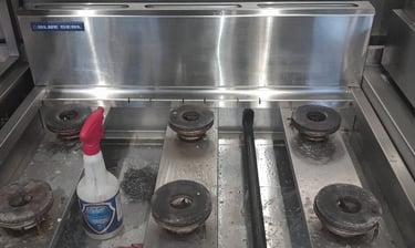 a stove top with a bottle of liquid on it