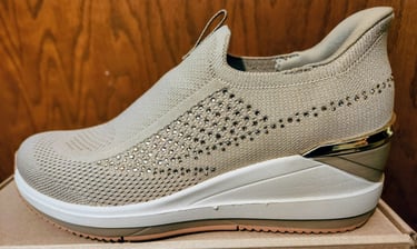 A side view of a sporty wedge shoe from Skechers