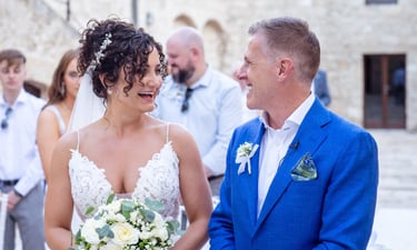 a bride and groom standing in front of a wedding ceremony