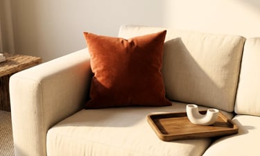 earthy tones living room color scheme with terracotta velvet cushion beige sofa and warm wood tray